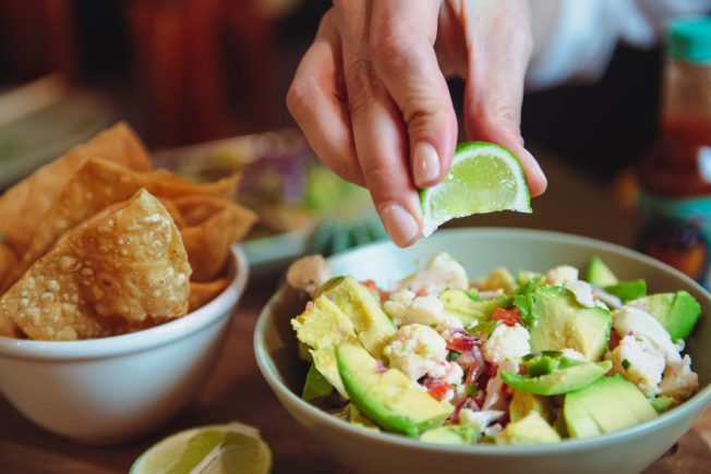 Cauliflower ceviche with hand squeezing lime