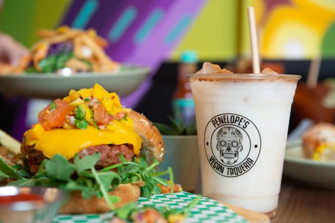 Impossible burger with mango pico next to a horchata beverage