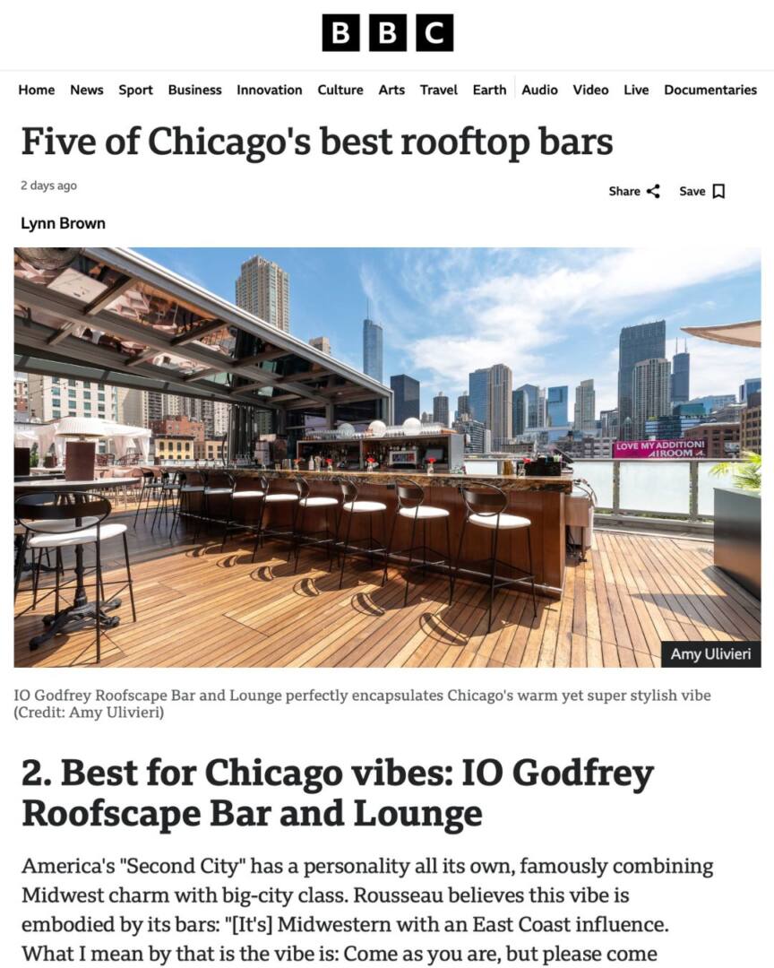 Photograph by Amy Ulivieri of AU Creates showing IO Godfrey Rooftop Bar and Lounge in Chicago. The open-air deck features sleek bar seating, modern wood flooring, and skyline views under a bright blue sky—capturing Chicago’s signature mix of warmth and style.